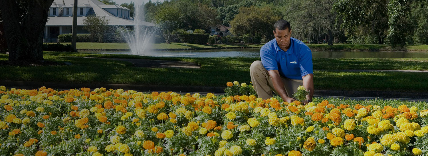 ABM groundskeeper doing landscape maintenance and turf management services
